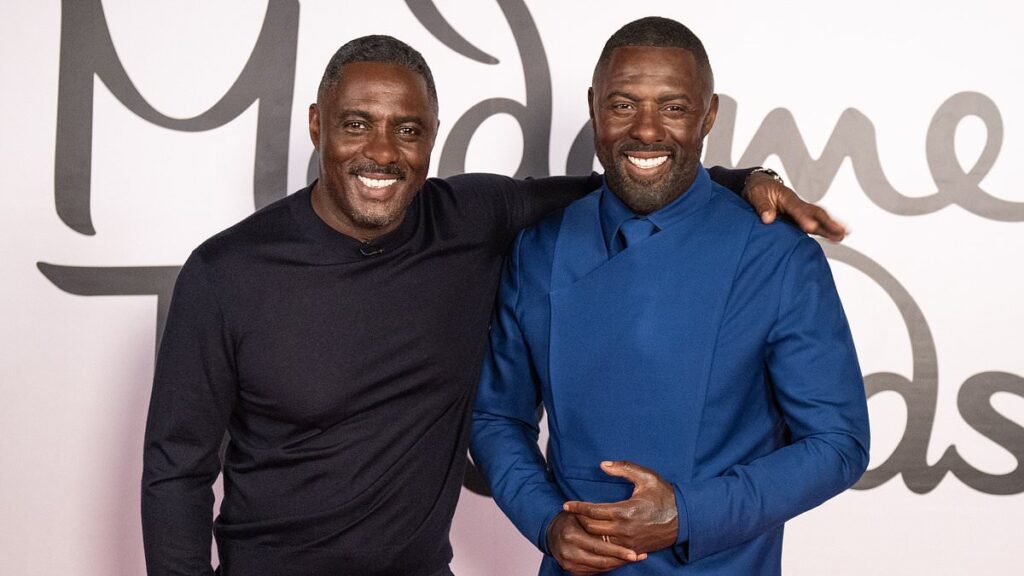 Idris Elba looks delighted as he poses next to his lookalike waxwork at the unveiling of the figure at Madame Tussauds in London