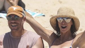 Candice Warner shows off her bikini body as she and her husband David celebrate Christmas Eve at a Sydney beach