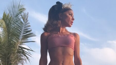 Kate Beckinsale, 52, poses in a pink bikini and huge platform boots before defiantly hitting back at body-shaming trolls