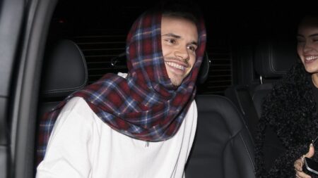 Romeo Beckham, 23, is all smiles as he brushes off family feud while heading to a party in Paris with girlfriend Kim Turnbull, 24, following estranged brother Brooklyn’s scathing statement