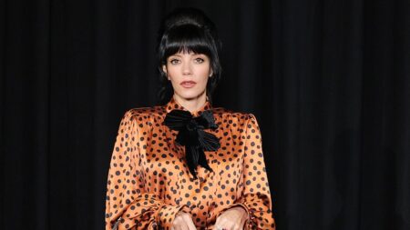 Lily Allen turns heads in a bold 60s inspired outfit as she joins Dakota Johnson at the star-studded Valentino show during Paris Fashion Week