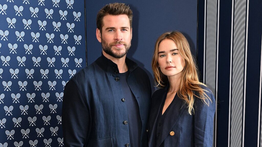 Liam Hemsworth’s model fiancée Gabriella Brooks shows off her massive diamond engagement ring as the pair step out in matching outfits at Australian Open