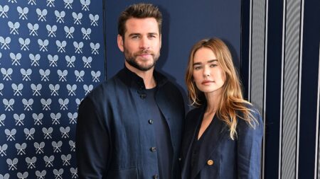 Liam Hemsworth’s model fiancée Gabriella Brooks shows off her massive diamond engagement ring as the pair step out in matching outfits at Australian Open