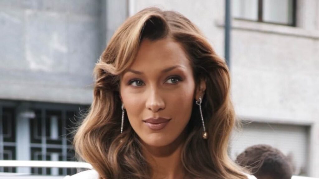 Bella Hadid shows off her tiny waist in a cinched satin blazer and skirt as she attends a brunch for Orebella in Milan