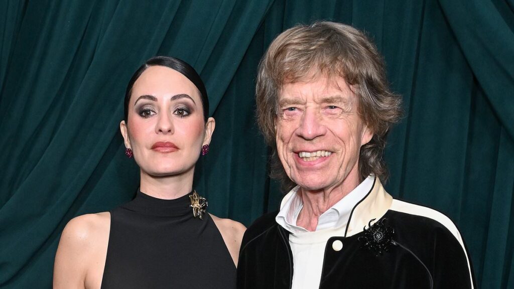 Mick Jagger, 82, wraps an arm around braless fiancee Melanie Hamrick, 38, at starry pre-Oscars bash