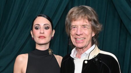 Mick Jagger, 82, wraps an arm around braless fiancee Melanie Hamrick, 38, at starry pre-Oscars bash