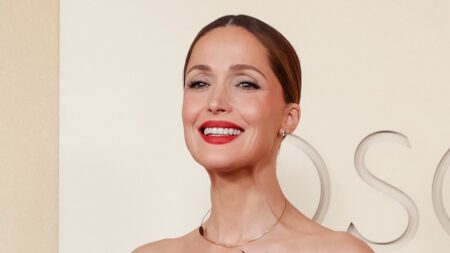 Rose Byrne stuns in floral strapless Dior dress and a HUGE diamond choker as she arrives at the 2026 Academy Awards with her husband Bobby Cannavale