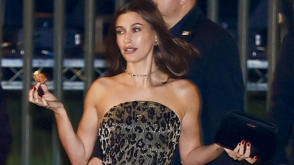Hailey Bieber clings onto a doughnut, supermodel Vittoria Ceretti bites into a burger and Julia Fox grabs a handful of canapes as they depart the Vanity Fair party