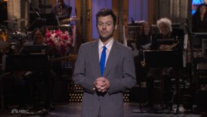 Harry Styles Addresses Queerbaiting Claims on ‘SNL,’ Ends Monologue With Ben Marshall Smooch: “Now That’s Queerbaiting”