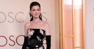 Anne Hathaway Blooms in a Show-Stopping Floral Gown With Opera Gloves on the 2026 Oscars Red Carpet