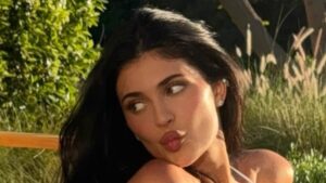 Kylie Jenner bares her cleavage in plunging bikini as she takes a dip for sizzling photos