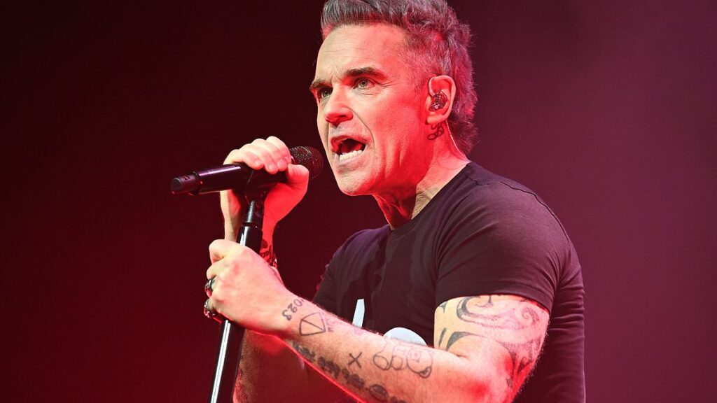 Robbie Williams hits back at ‘cruel’ podcast host with scathing response after he is branded a ‘Redcoat and a fraud’: ‘You’re a real bully!’
