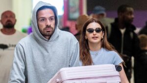 Injured Jack Grealish has the holiday blues as he touches down in Heathrow with girlfriend Sasha Attwood with trolley full of luggage after Barbados trip