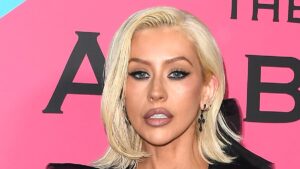 Christina Aguilera looks thinner than ever with a plumper pout alongside youthful Carmen Electra at West Hollywood event