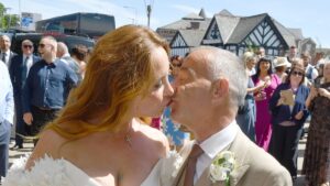 Coronation Street star Michael Le Vell is married! Actor, 61, shares a kiss with his wife Louise Gibbons as pair tie the knot after 12 year romance