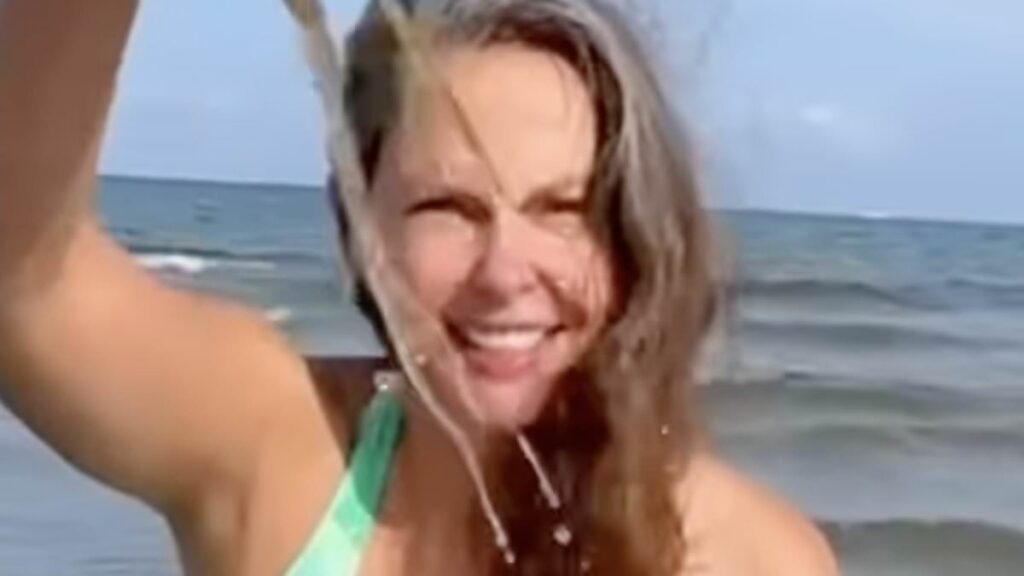 Ashley Judd slips into plunging green and white swimsuit at 58 as she frolics in the Baltic Sea