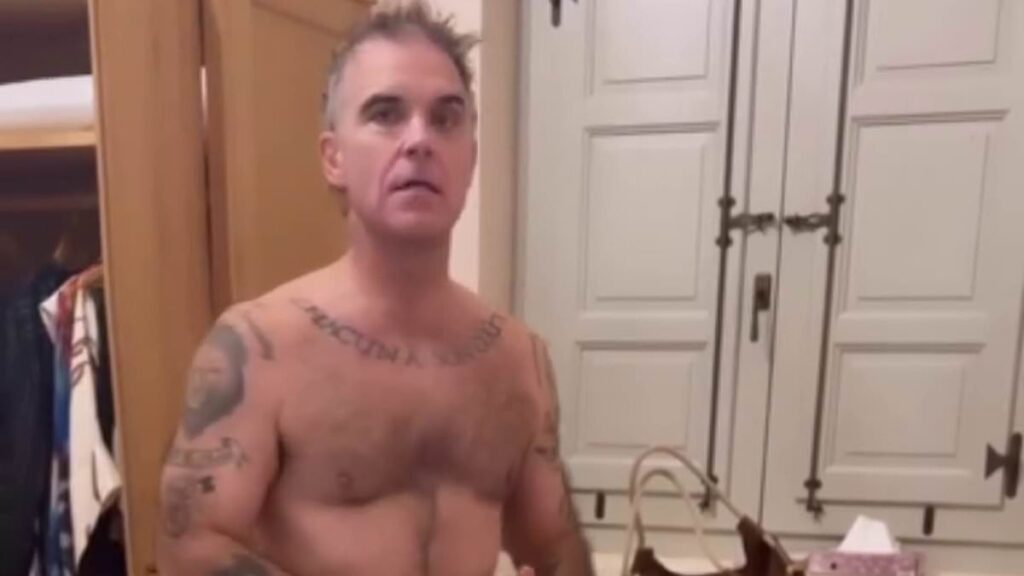 Robbie Williams, 52, strips to his pants as he debates wearing ‘lucky clothes’ for England’s World Cup match with wife Ayda