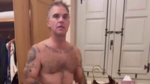 Robbie Williams, 52, strips to his pants as he debates wearing ‘lucky clothes’ for England’s World Cup match with wife Ayda