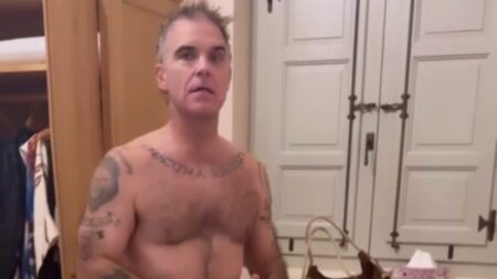 Robbie Williams, 52, strips to his pants as he debates wearing ‘lucky clothes’ for England’s World Cup match with wife Ayda