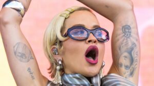 Rita Ora shows off her impressive abs in a silver bralet and skimpy skirt as she commands the stage at the Isle of Wight Festival