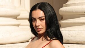 Charli XCX turns heads in a sexy red dress as she joins lace-clad Daisy Edgar-Jones at the star-studded Saint Laurent show during Men’s Paris Fashion Week