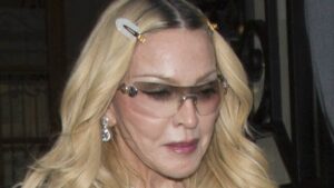 Madonna, 67, suffers embarrassing wardrobe mishap in VERY short blue dress during Paris Fashion Week
