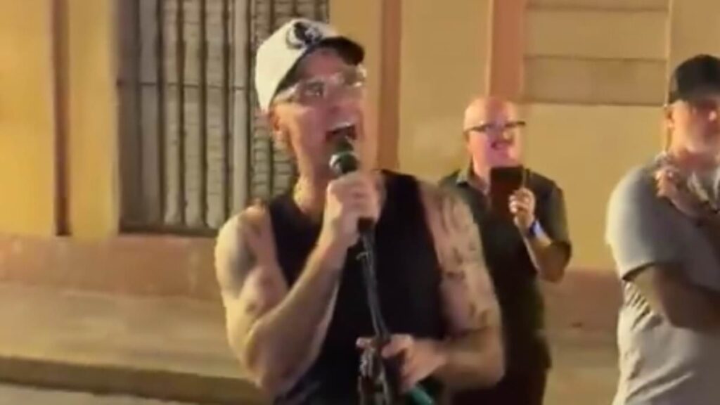 Robbie Williams stuns Spanish locals as he joins a busker with a surprise performance of his hit song Angels in the streets of Seville