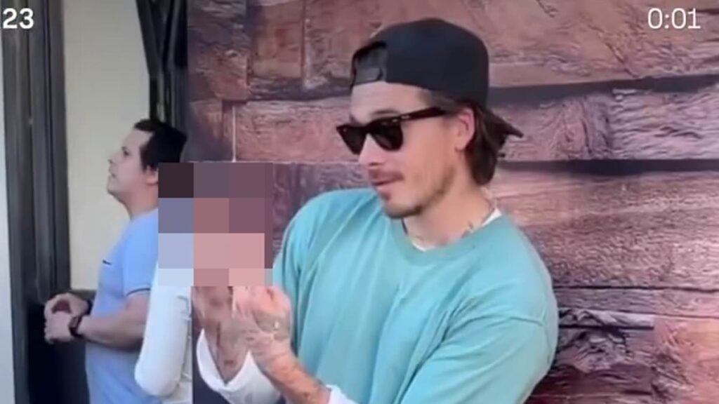 Brooklyn Beckham gives a two-finger salute as he admits wife Nicola Peltz isn’t a fan of his fashion while sporting £715 Balenciaga boots and ‘caretaker’ keys