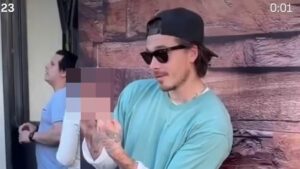 Brooklyn Beckham gives a two-finger salute as he admits wife Nicola Peltz isn’t a fan of his fashion while sporting £715 Balenciaga boots and ‘caretaker’ keys