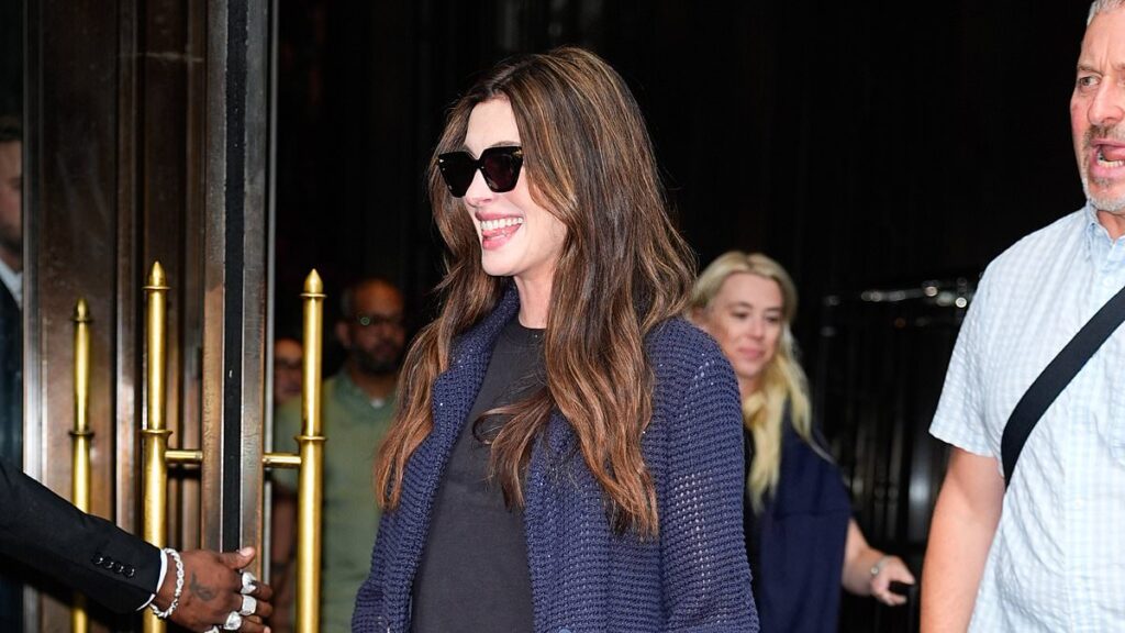 Pregnant Anne Hathaway flashes her blossoming baby bump as she steps out in NYC before later appearing in glamorous yellow velvet gown