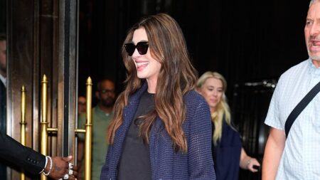 Pregnant Anne Hathaway flashes her blossoming baby bump as she steps out in NYC before later appearing in glamorous yellow velvet gown