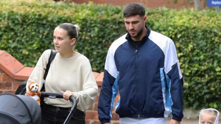 Molly-Mae Hague and Tommy Fury put on a weary display as they step out with Bambi, three, and newborn Midas – after saying she’s ‘winging it every day’ and joking about ‘mile long roots’