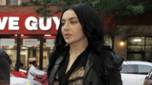 Charli XCX turns heads as she flashes her bra in a sheer lace top while leaving her album listening party in New York City