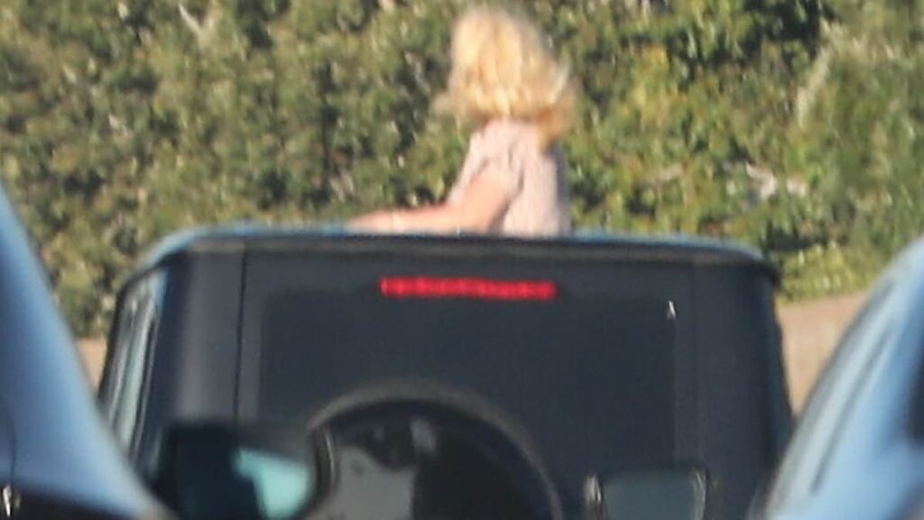 Britney Spears horrifies drivers as she CLIMBS OUT of car roof on busy freeway months after DUI arrest