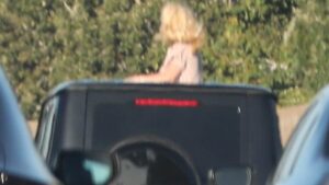 Britney Spears horrifies drivers as she CLIMBS OUT of car roof on busy freeway months after DUI arrest