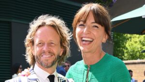 Davina McCall looks loved-up with husband Michael Douglas as they lead the stars on day 13 of Wimbledon