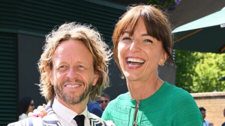 Davina McCall looks loved-up with husband Michael Douglas as they lead the stars on day 13 of Wimbledon