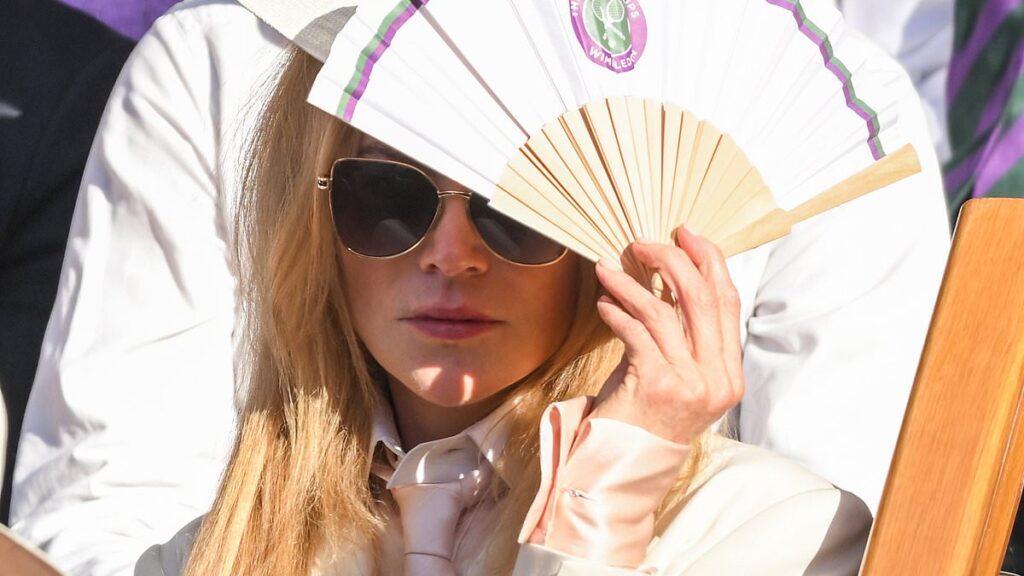 Nicole Kidman has a face of thunder as her famous pale skin is scorched by the sun at Wimbledon