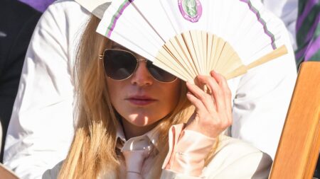 Nicole Kidman has a face of thunder as her famous pale skin is scorched by the sun at Wimbledon