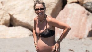 Pregnant Vogue Williams, 40, shows off her baby bump in a leopard print bikini as she hits the beach in Spain with shirtless Spencer Matthews ahead of welcoming fourth child
