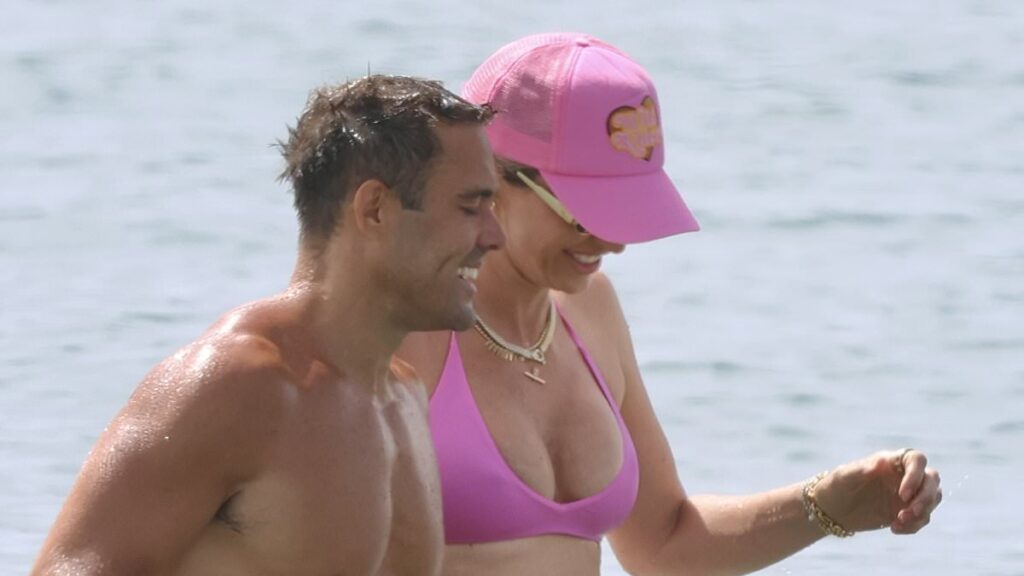 Pregnant Vogue Williams shows off her bump in a pink bikini as she hits the beach with shirtless Spencer Matthews in Spain