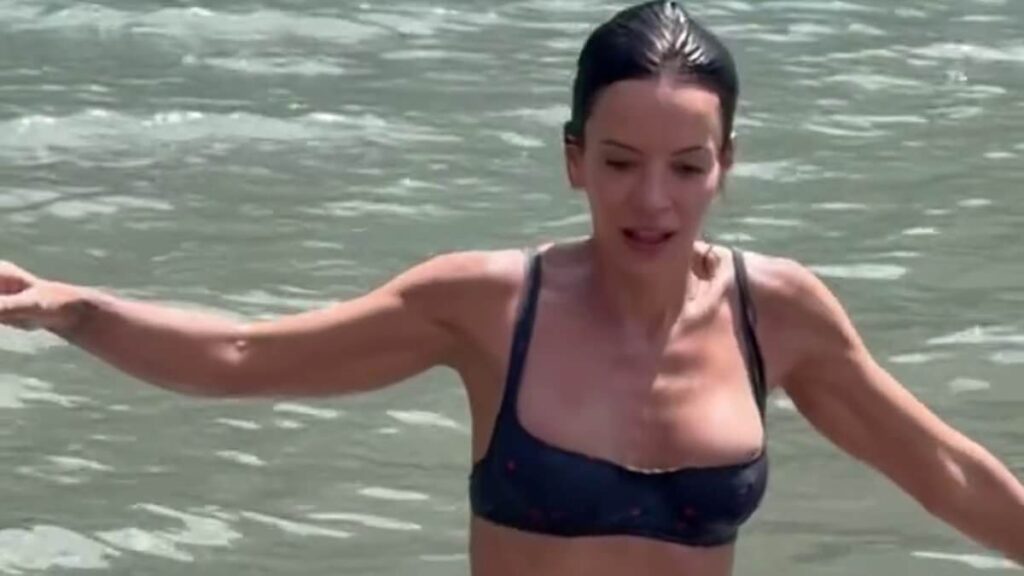 Lily Allen stuns in a barely-there bikini as she enjoys a swim in the sea during her European getaway