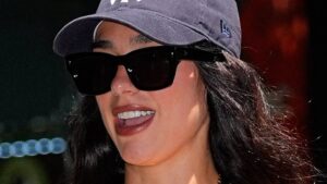 Dua Lipa embraces the New York heatwave in a low-cut spotted dress and £22,000 Hermes Birkin as she heads out in the city