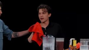 Tom Holland becomes the first celebrity to fall sick live on air after taking on the Hot Ones challenge