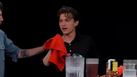 Tom Holland becomes the first celebrity to fall sick live on air after taking on the Hot Ones challenge