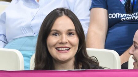 Pregnant Holly Ramsay smiles as she arrives to watch husband Adam’s 100m breaststroke final at the Commonwealth Games