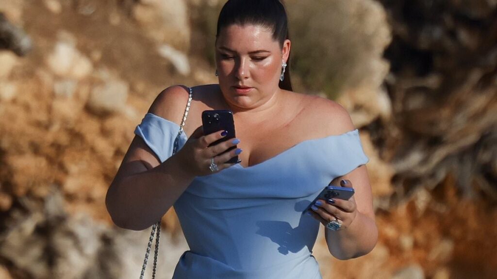 And the bride wore blue! Billionaire heiress Francesca Packer wears a daring thigh-split gown for her wedding celebrations with husband Robert Bates in Mallorca – and stays glued to her phone the entire time