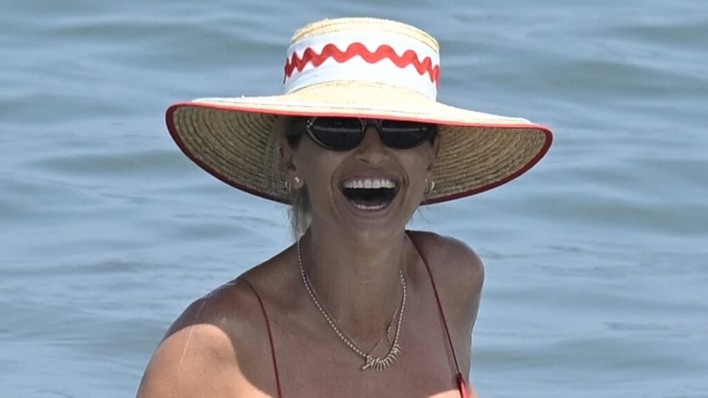 Pregnant Vogue Williams giggles in a raspberry red bikini as she hits the sea with shirtless husband Spencer Matthews in Marbella