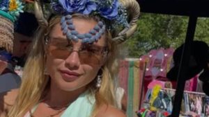 Florence Pugh wows in plunging feathered mini dress and horned headdress as she parties at star-studded Wilderness Festival