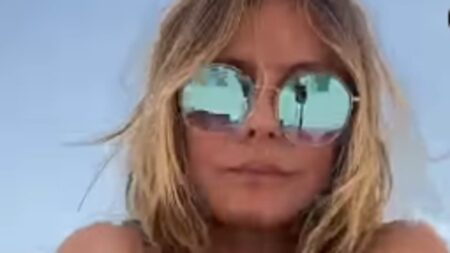 Heidi Klum, 53, cheekily poses topless and kisses husband Tom Kaulitz, 36, on the beach as they celebrate their seventh wedding anniversary in St Barts